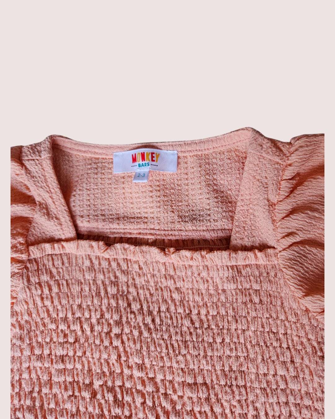 Monkey Bars smocked cap sleeve tee in a super cute peach colour 2-3T